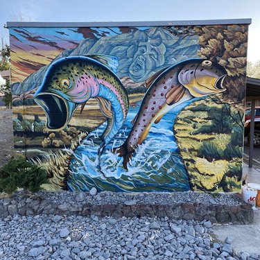 Truckee Lovers – This past weekend we created this #mural in the #fernleymuralfest in Nevada. Daniela wrote and designed a love story based on a Native American story of a woman that would sing by the river every day. The local Trout King began to fall in love with the local singer and dug a canal to get closer to her. By the time the Trout King reached the lady singer they fell in love and the #trout turned the singer into a fish so they could be together. 

Thank you to all the artists and especially iamsierraarts for allowing us to be a part of this amazing festival in Fernley. 
 
#murals_of_baltimore #morearteverywhere #renoartists #renoartscene #nevadaartists #sierraartsfoundation #nevadaart #muralart #streetmural #artinthestreets #urbanart #muralpainting #muralsofinstagram #wallart #streetartworldwide