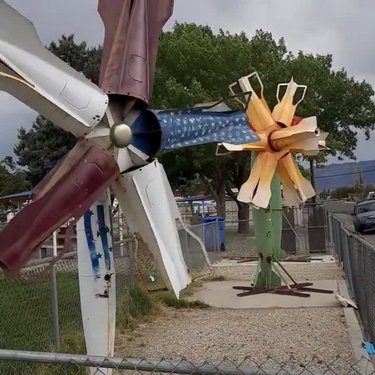 Flower windmills made out of missile parts in Hawthorne, Nevada, the biggest munitions depot in the United States. We are in yet another dog park.

#HomeMeansNevada