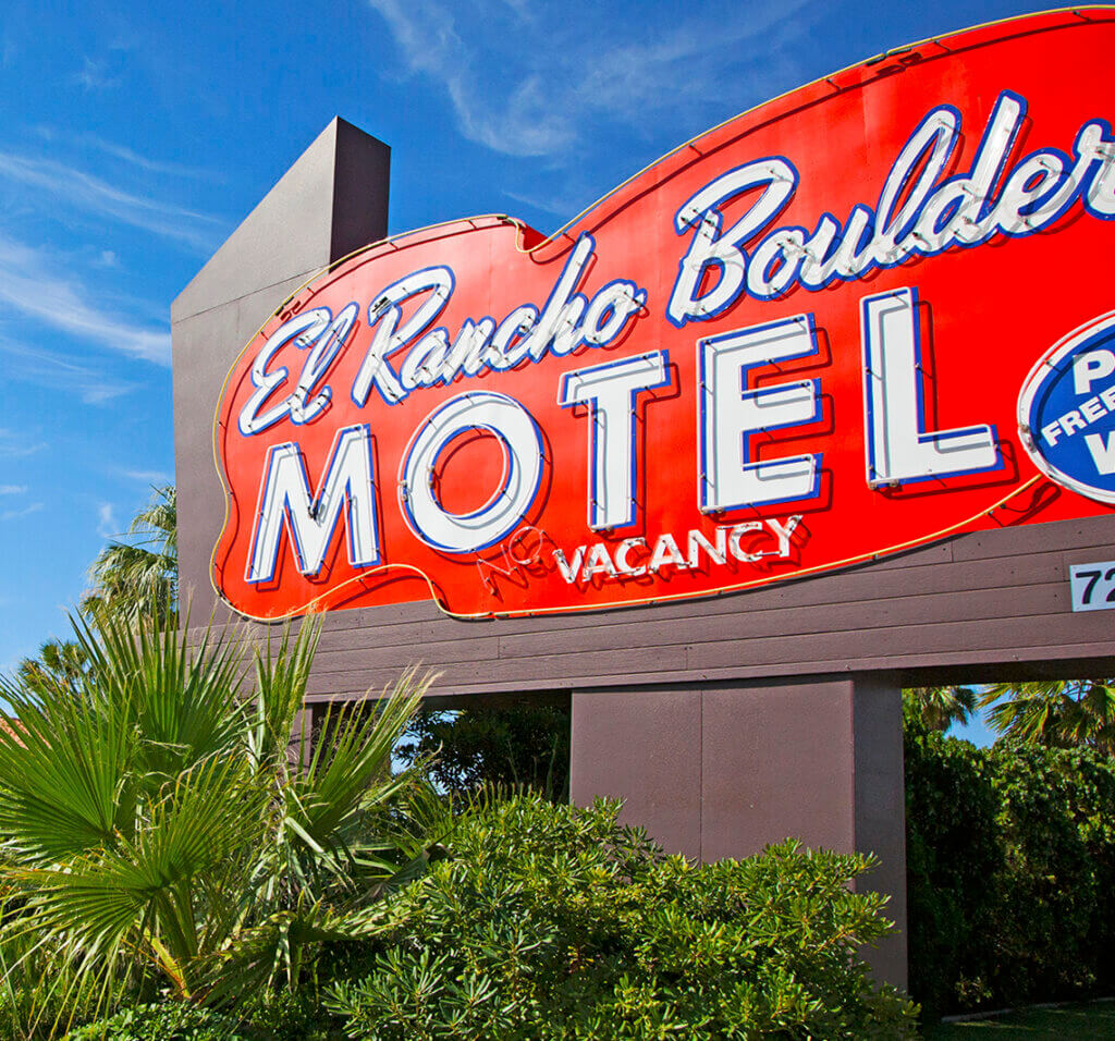 red neon sign for the el rancho boulder motel