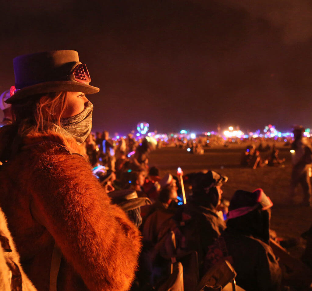 people watching a show at burning man