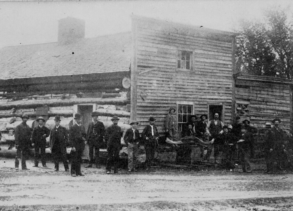 crowd of people standing outside of the historic mormon station