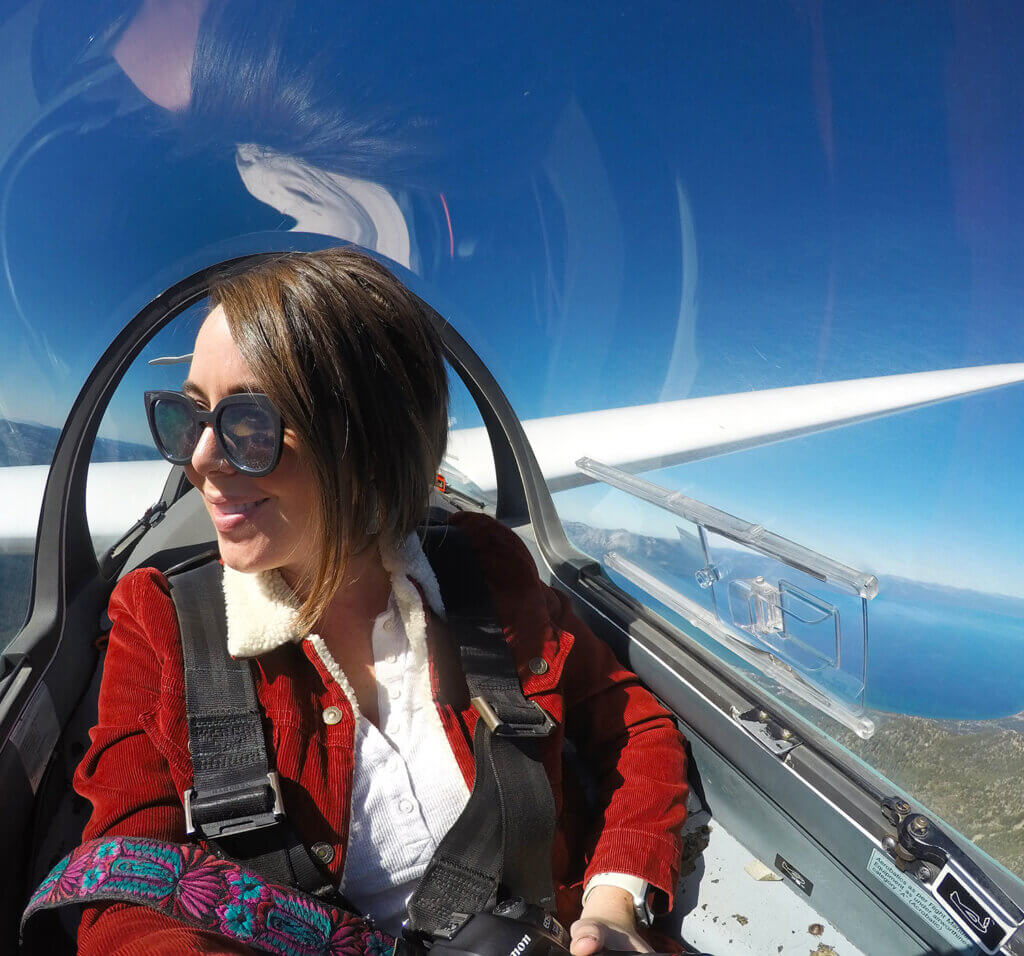 woman soaring over lake tahoe in a glider