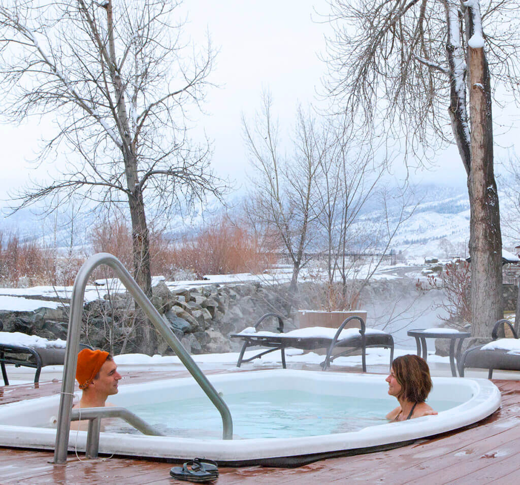 couple enjoying a hot tub in the winter