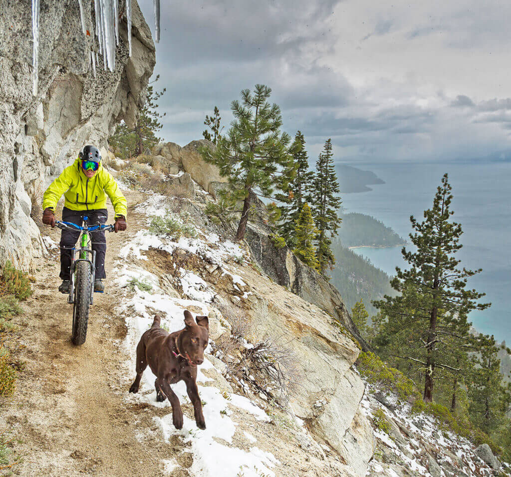 mountain biking flume trail with a dog