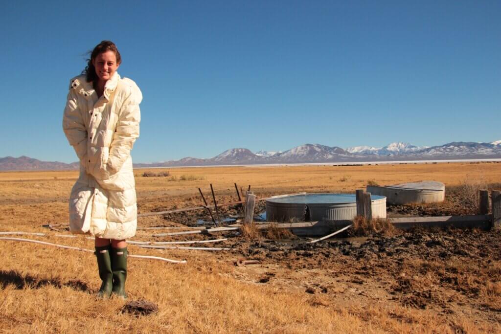 woman wearing a jacket outside of a hot spring