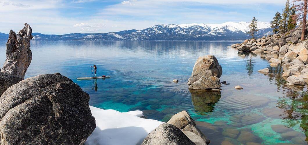 Paddle board on Tahoe with snow.