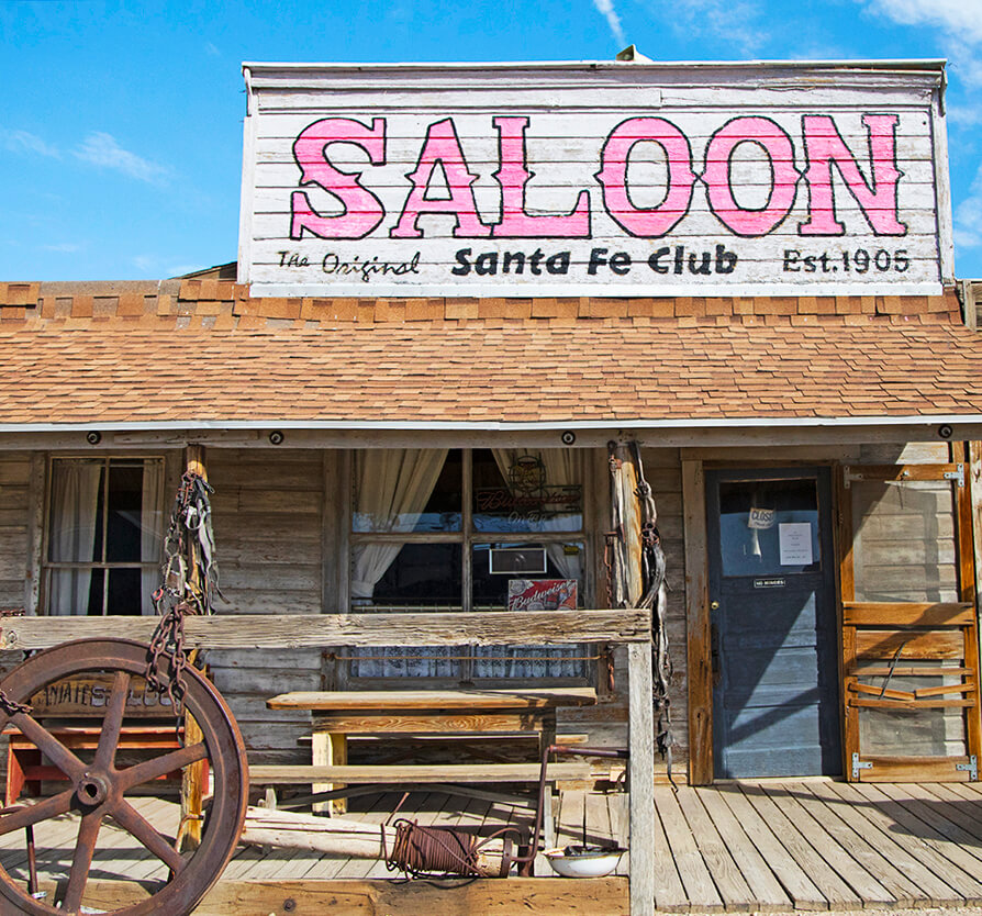 wagon wheel in front of the santa fe saloon