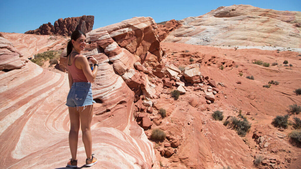 woman exploring sculpted stone at the valley of fire